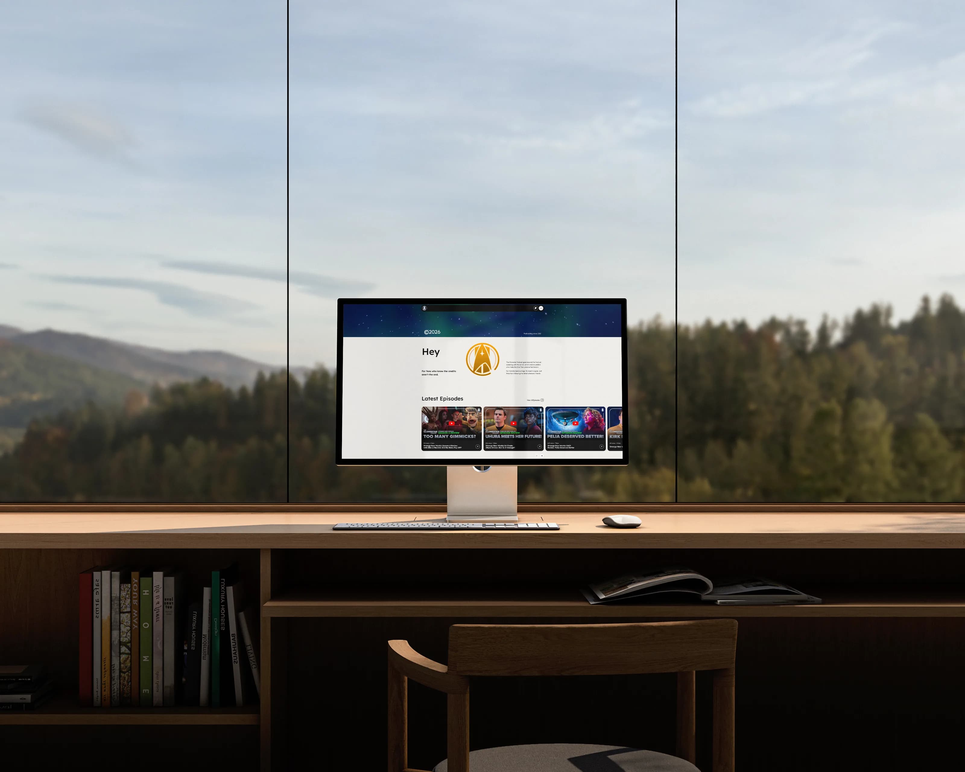 The Clonestar Podcast website on a large monitor in a bright studio, hills beyond the window